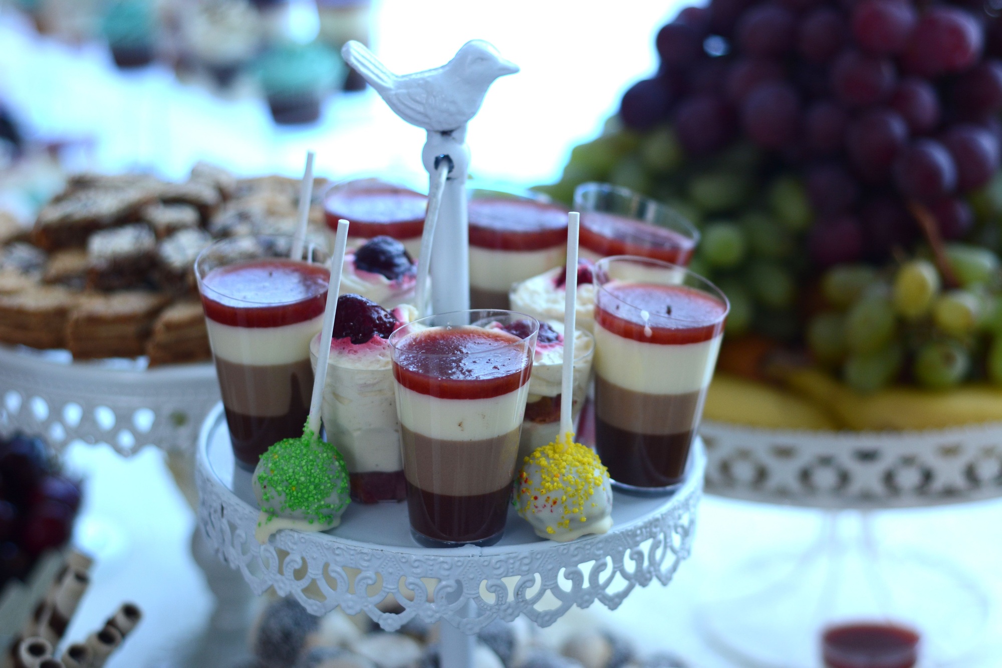 Pudding in layers with cocoa, strawberries, whipped cream, cappuccino and fruit combined with fondan