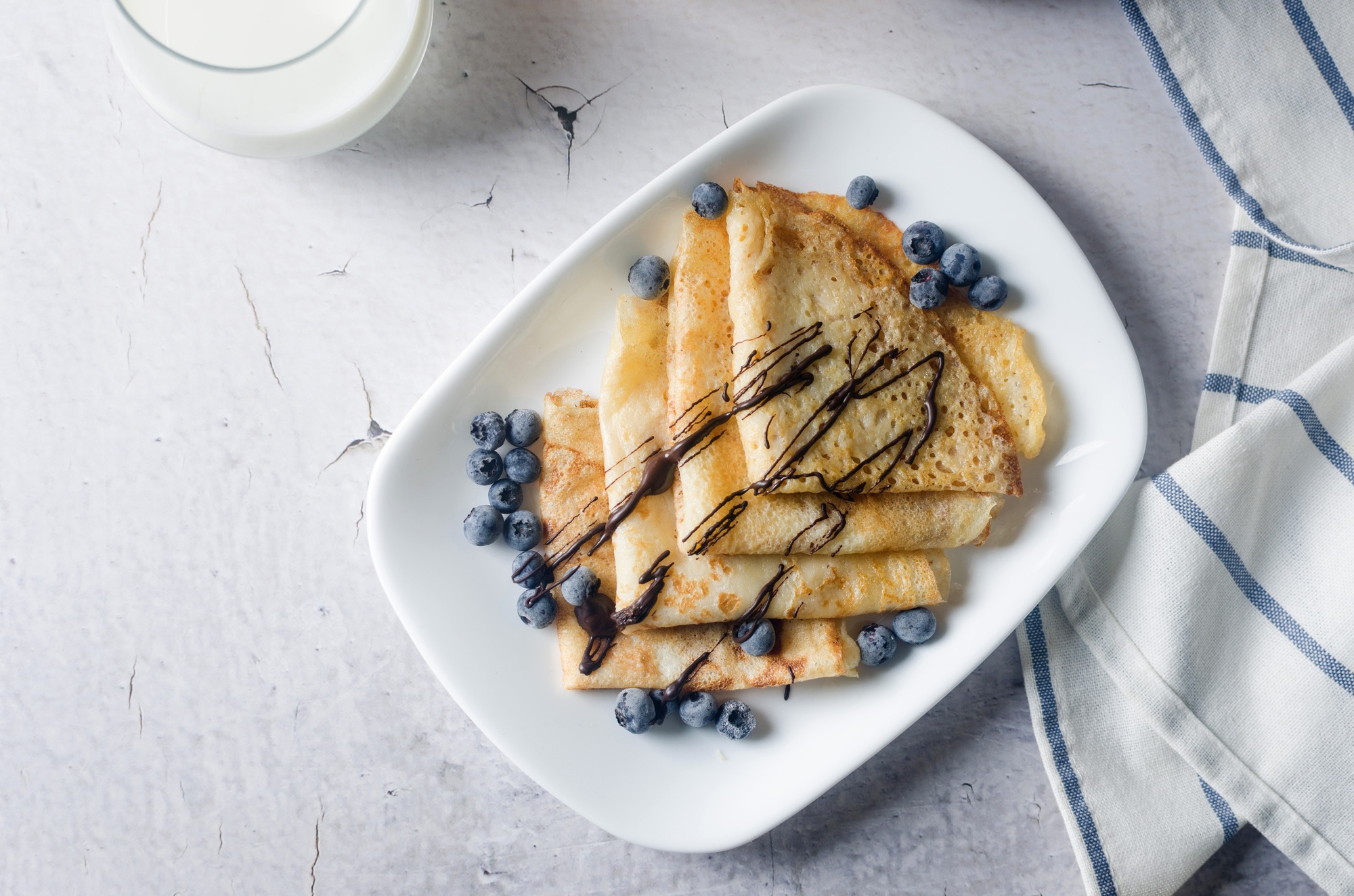 Thin homemade pancakes with berries, traditional Russian cuisine.